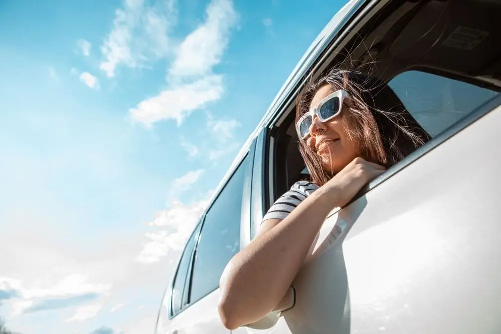 Woman,Looking,Out,From,Car,Window.,Road,Trip,Travel,Concept.