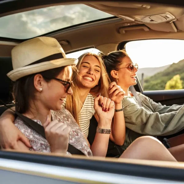 Three best female friends travel together.They drives a car and making fun.Summer adventure